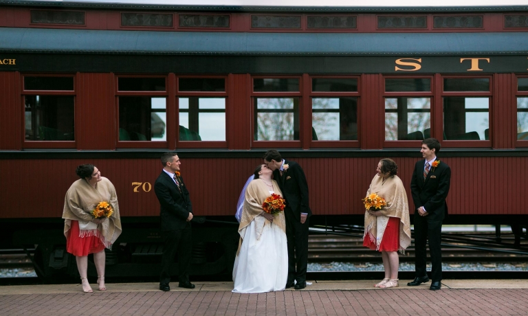 Modern wedding photo in front of train.