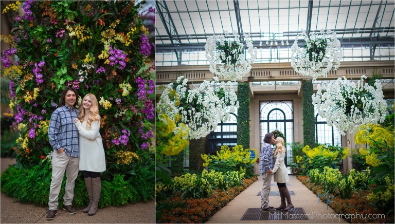 Engagement photo of couple kissing in the Orangery at longwood gardens in front of Orchids.
