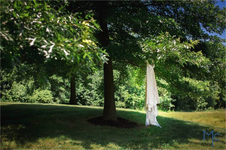 Photo of wedding dress hanging outisde Joseph Ambler Inn