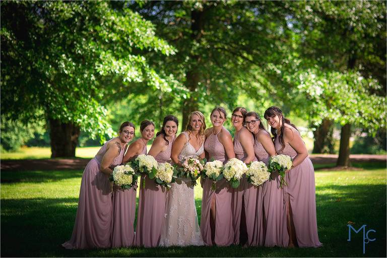 Joseph Ambler Inn Wedding bride and bridesmaids group photo in front of trees
