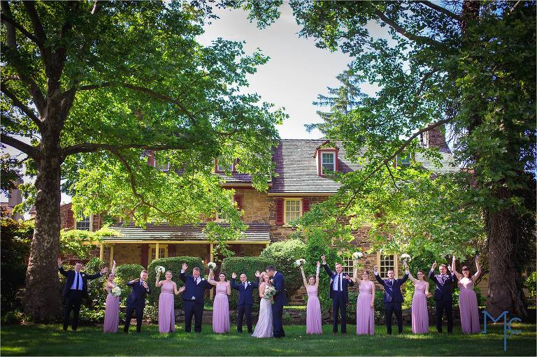 Joseph Ambler Inn Wedding full wedding party photo in front of stone building