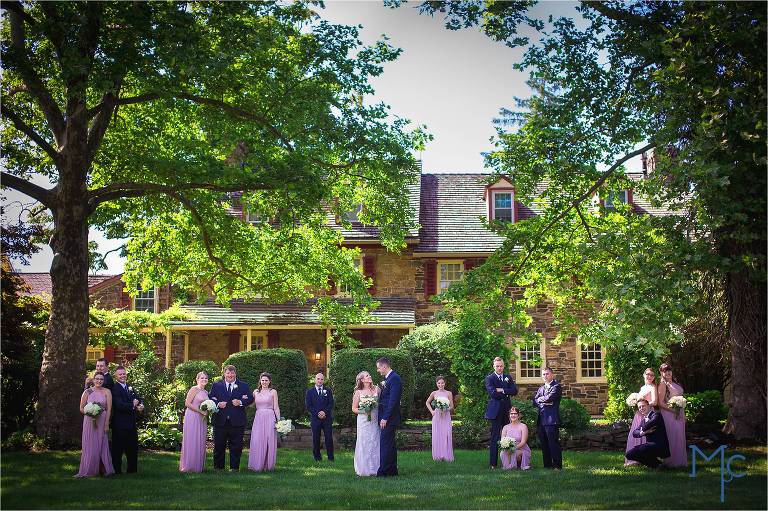 Joseph Ambler Inn Wedding full wedding party photo in front of stone building