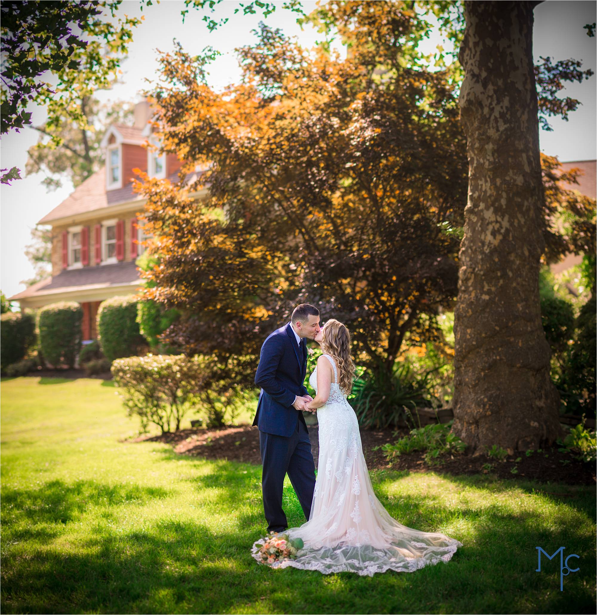 Joseph Ambler Inn Wedding bride and groom portrait outside among sycamore and Japanese maple tree. Beautiful lighting
