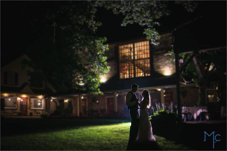 Joseph Ambler Inn Wedding bride and groom night photo outside backlit against old stone barn